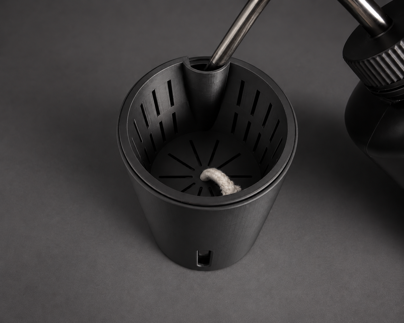 Black medium cup showing the inner pot and refill opening with a watering bottle
