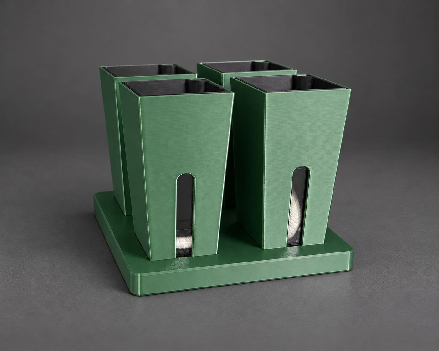 Four forest green small self-watering cups in their matching base