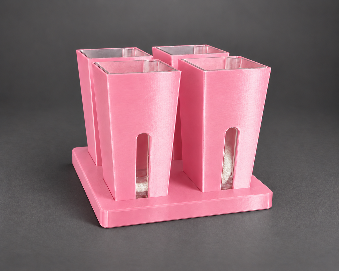 Four silk pink small self-watering cups in their matching base