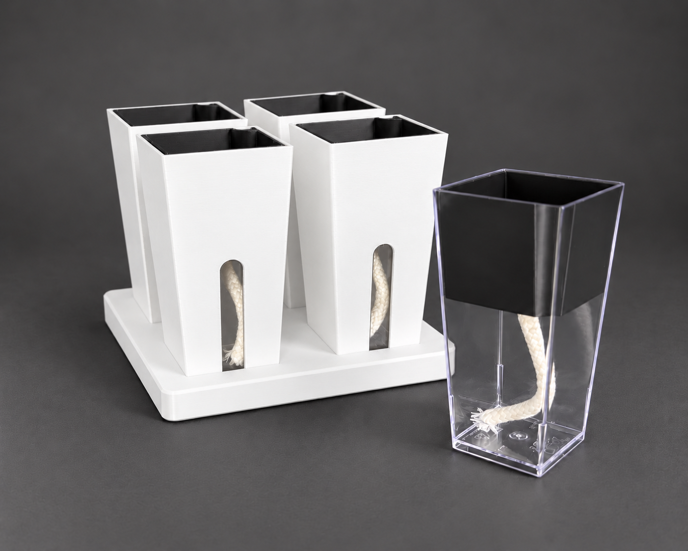 White small cups with the clear reservoir, removable inner pot, and wick shown