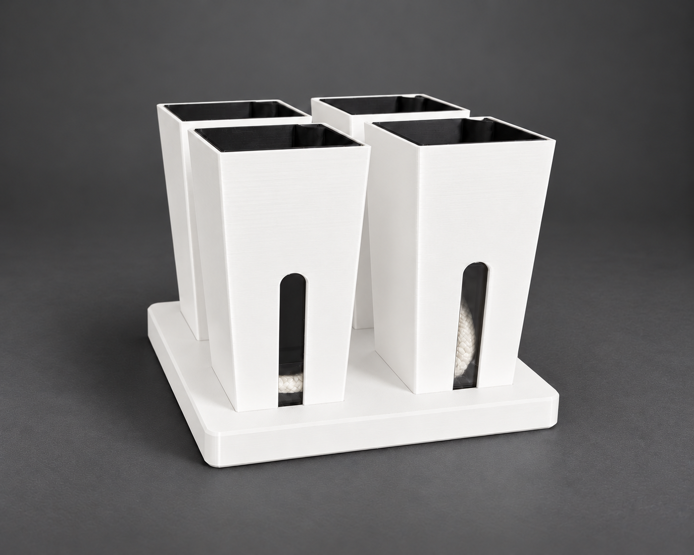 Four white small self-watering cups in their matching base